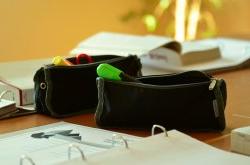pencil cases and binders on a desk