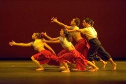 Photo of five dancers leaning dramaticall toward something out of frame.