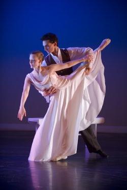 Photo of male and female dancers in flowing clothes.